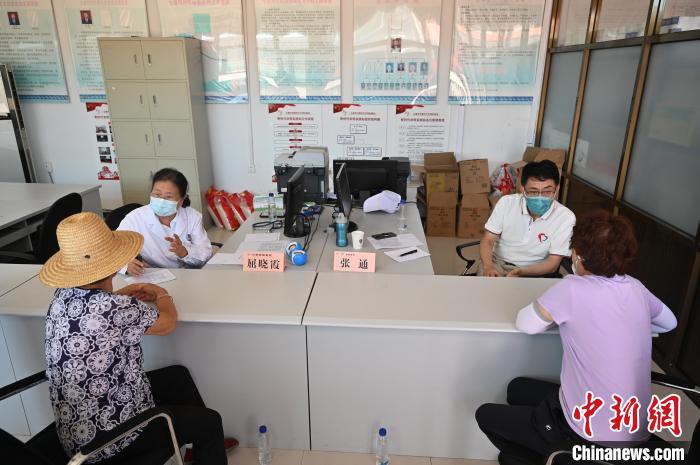 7月7日，张通教授(右二)、屈晓霞副主任医师(左二)在七道河村为村民义诊。　张兴龙 摄